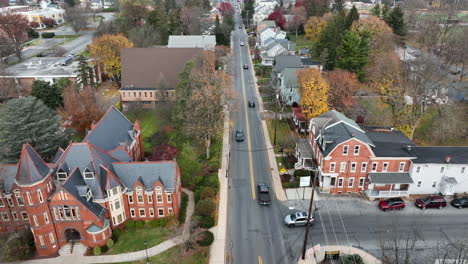 Aerial-pullback-reveal-of-large-Gothic-mansion-museum-on-university-college-campus,-Millersville-University