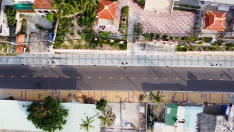 Calm-Street-In-Vietnam,-Palm-Trees-And-No-Traffic,-Top-Down-View,-Aerial
