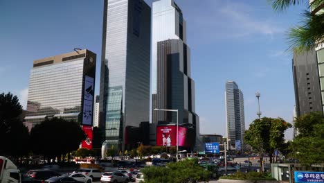Traffic-and-pedestrian-time-lapse-near-WTC-Seoul,-South-Korea-near-the-COEX-Mall-and-Samseong-Station,-Grand-InterContinental-Hotel-Parnas-and-Trade-Tower---pitch-up