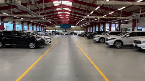 Slow-dolly-shot-of-cars-inside-Carvolution-HQ-in-Bannwil,-Switzerland
