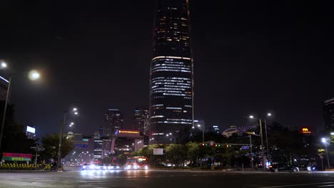 Lotte-World-Tower-at-night-in-Seoul-with-cars-traffic-on-crossroads