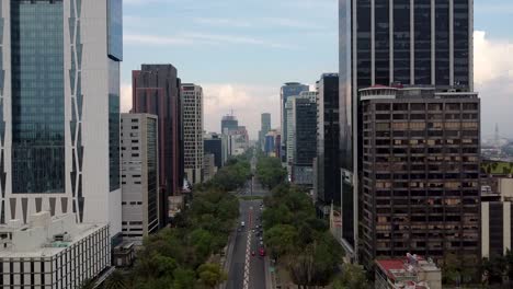 Aerial-View-Along-Paseo-de-la-Reforma-with-Skyscrapers-and-the-Palm-Roundabout,-Mexico-City