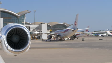 Airbuses-Of-Air-Algerie-Parked-At-The-Apron-Of-Algiers-Airport-In-Algeria-With-Close-Up-Of-Engine-Turbine-In-Foreground