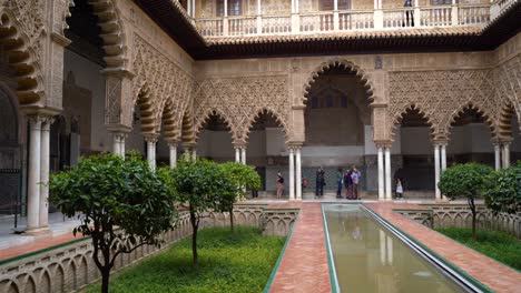 Right-to-left-pan-insisde-Alcazar-in-Seville,-Spain-with-few-people