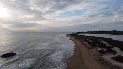 Calmer-aerial-drone-flight-stable-tripod-drone-shot-of-a-lonely-empty-castaway-mystic-beach-at-sunset