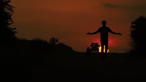 Back-view-of-man-walking-on-the-street-during-sunset-time-at-Diu-city-of-India