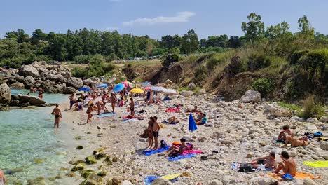 Tourism-at-Cala-Mazzo-di-Sciacca-rocky-beach-near-Scopello,-Sicily-in-Italy