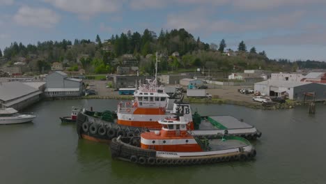Located-in-Coos-Bay,-Oregon-over-the-Isthmus-Slough,-showing-tug-boats-at-Coos-Tug-Boat,-shot-with-a-DJI-Mavic-3-drone