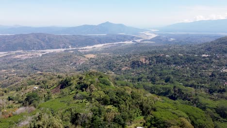 Aerial-rising-over-forested-vast-wilderness-landscape-with-Mt-Ramelau-mountain-in-Ermera-district,-coffee-growing-region-,-Timor-Leste,-Southeast-Asia