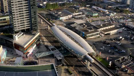 Aerial-backward-drone-shot-of-Brentwood-Town-Centre-Skytrain-Station-and-its-surroundings