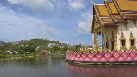 Panning-shot-of-the-Wat-Plai-Laem-temple-located-on-a-lake-in-Koh-Samui-on-a-hot-sunny-day