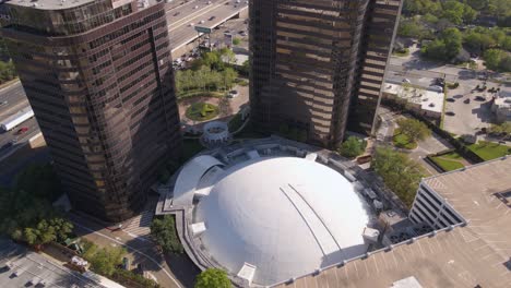 Aerial-view-overlooking-the-Arena-Theatre,-in-sunny-Houston,-USA---tilt,-drone-shot