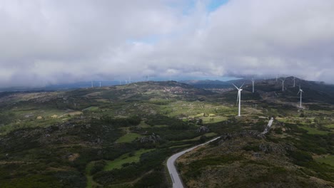 One-person-on-Caramulinho-viewpoint-and-eolic-wind-turbines-in-background