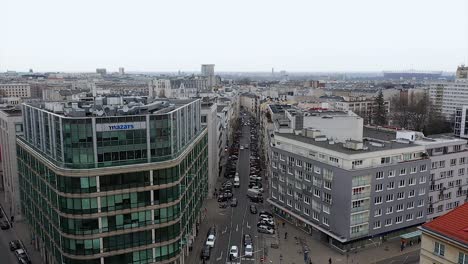 Aerial-view-low-over-the-Mokotowska-street-in-cloudy-Warsaw,-Poland---reverse,-drone-shot