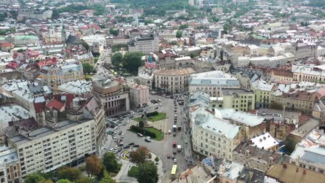 Old-historical-European-city-with-cars-driving-along-the-road-of-Lviv-Ukraine-and-the-skyline-in-the-background
