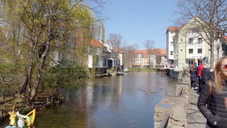 Walking-Through-Sunny-Erfurt-next-to-River-Gera-and-Merchants-Bridge