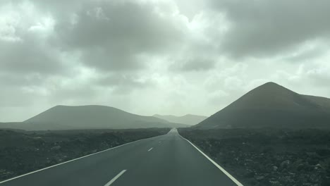 Dash-cam-point-of-view-driving-in-Lanzarote-with-volcanoes