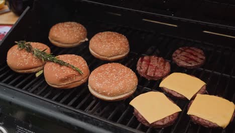 Slow-motion-footage-of-hamburgers-and-cheese-being-grilled-on-a-barbecue-stand