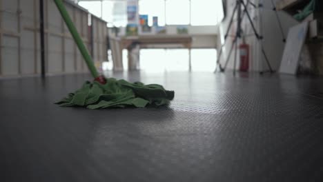 Man-cleaning-linoleum-floor-using-mop-Medium-Shot