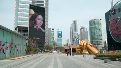 Establishing-shot-of-the-Gangnam-golden-hands-statue-at-the-Coex-business-complex-looking-down-Yeongdong-daero-street