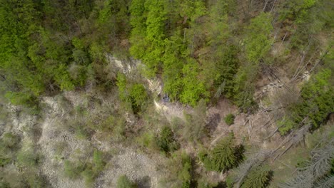 View-of-the-rocky-ridge-in-the-forest-in-the-valley-on-a-sunny-spring-day,-Hřebeč-Moravská-Třebová,-Czech-Republic---aerial-view