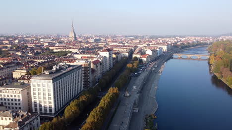 Aerial-Reveal-Turin-City-and-Mole-Antonelliana-next-to-River-Po,-Fall