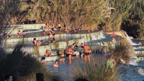 People-relaxing-in-the-thermal-pools-as-water-cascades-down-through-the-levels