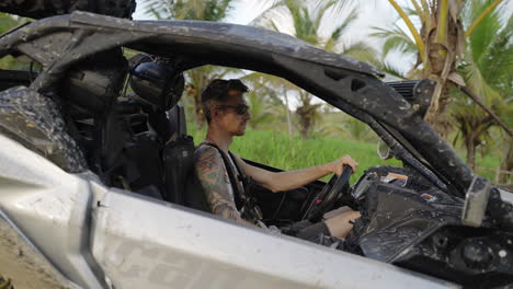 Male-Sitting-In-Dirt-Buggy-With-Sunglasses-Turning-To-Camera-In-Punta-Cana