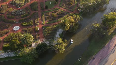 Couple-on-pedal-boats-at-sunset-in-Palermo-Lakes,-Tres-de-Febrero-park-at-Buenos-Aires-city-in-Argentina