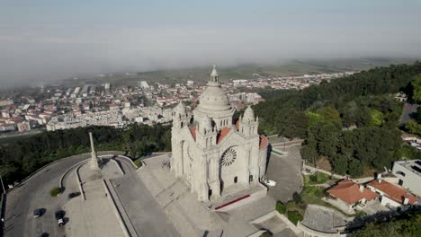 Orbital-view-of-Santa-Luzia-church-sanctuary-on-hilltop-of-Viana-Do-Castelo,-Portugal-on-cloudy-day