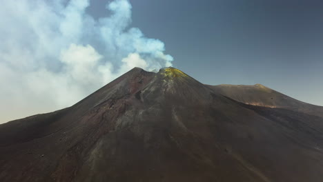 Mount-Etna-rotating-aerial-shot-with-smoke-or-steam-coming-out-of-the-active-volcano-in-Sicily-Italy