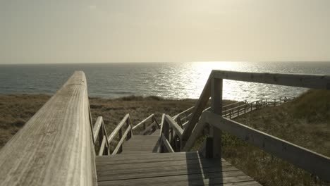 Boardwalk-trough-the-dunes-of-Sylt-with-the-Northsea-in-the-background-4k-60fps