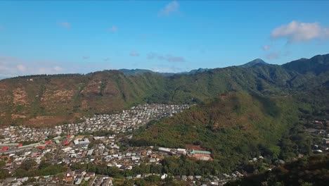 Aerial-view-of-homes-in-valley-surrounded-by-mountains-on-Oahu-Hawaii