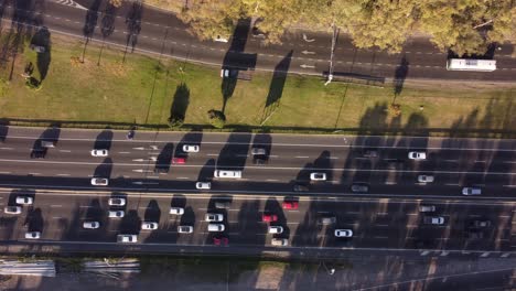 Top-down-aerial-view-of-busy-highway-during-sunset