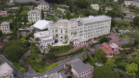 Aerial-push-in-of-majestic-5-star-Imperial-Palace-Hotel,-Santa-Margherita-Ligure