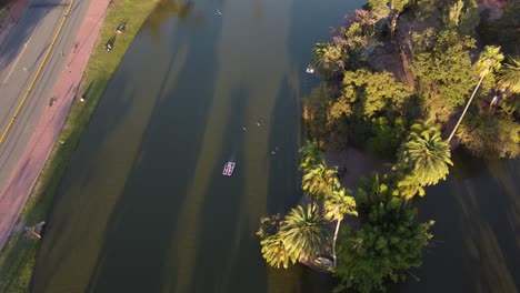 Tilt-aerial-view-of-pedal-boat,-Palermo-Lakes,-Buenos-Aires