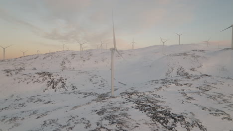 Wind-Turbine-In-Alternative-Energy-Farm-On-Snowy-Mountain,-Aerial
