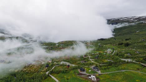Aerial-Hyperlapse-View-Of-Clouds-Rolling-Over-Remote-Town-In-Norway