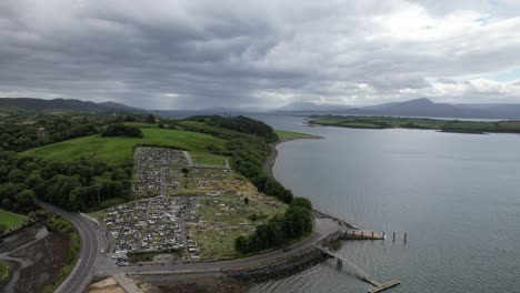 Cemetery-overlooking-sea-near-Bantry-west-County-Cork,-Ireland-aerial-drone-view