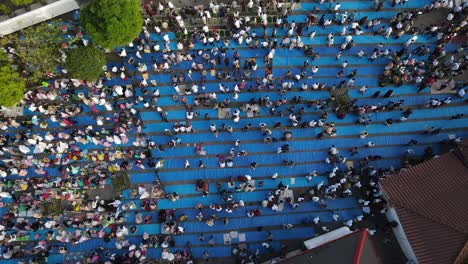 Aerial-view,-worshipers-praying-for-Eid-al-Adha-or-Eid-al-Fitr-in-the-courtyard-of-the-Kauman-Mosque-in-Yogyakarta,-they-began-to-disperse-and-return-to-their-respective-homes