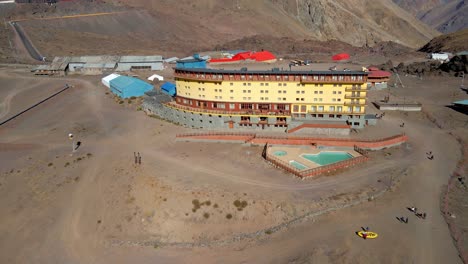 Aerial-view-dolly-in-of-the-Portillo-Hotel-in-Los-Andes,-Chile-on-a-sunny-day