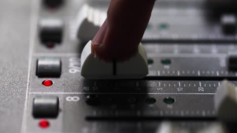 Person's-Index-Finger-Slide-Up-The-Fader-To-The-Maximum-Volume-Of-Mixing-Console