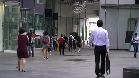 Office-workers-walking-at-Raffles-Place,-downtown-Singapore-central-business-district