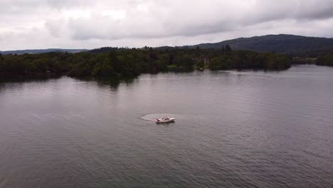 aerial-shot-passing-motorboat-on-lake-Windermere-lake-district