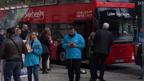 Tourists-taking-the-Lisbon-Sightseeing-bus-tour,-popular-service-for-people-visiting-the-city