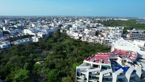 white-hotels-and-apartment-buildings-in-Playa-Del-Carmen-coastline-on-sunny-day,-aerial