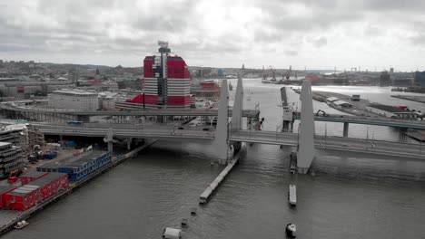 Newly-constructed-structure-in-Gothenburg,-the-modern-Gota-river-crossing,-Hisingsbron-bridge-against-overcast-sky-background---aerial-dolly-out-shot