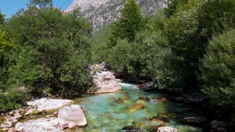 Turquoise-water-of-clean-river-streaming-on-beautiful-valley-of-Valbona-in-Albanian-Alps