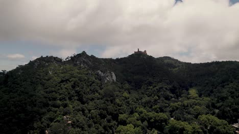 Sintra's-Natural-Park-with-distant-hilltop-Pena-Palace-against-cloudy-sky