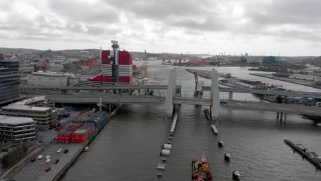 Aerial-descending-shot-capturing-the-vehicles-on-newly-built-infrastructure-Hisingsbron-bridge-crossing-the-Gota-river,-in-Gothenburg-metropolitan-area,-Sweden